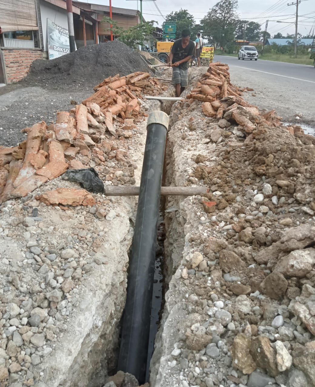 Pekerjaan penanaman pipa di Jalan lintas Medan-Banda, Gampong Sungai Lueng, Kecamatan Langsa Timur. (Foto Mediarealitas)